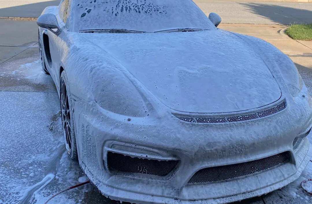 Exterior hand wash and wheel cleaning on a dark sedan